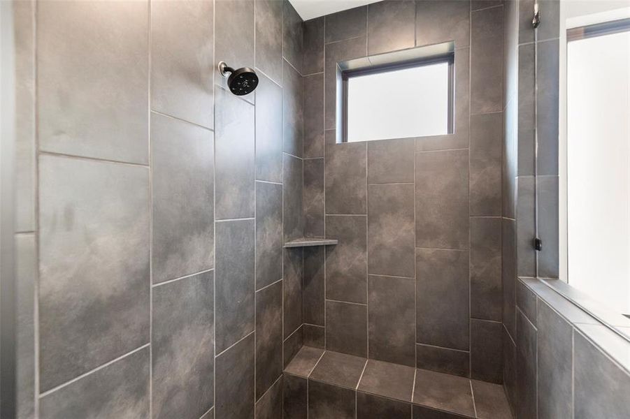 Elegant Tile and Bench Area in this Walk-in Shower in Primary Bathroom