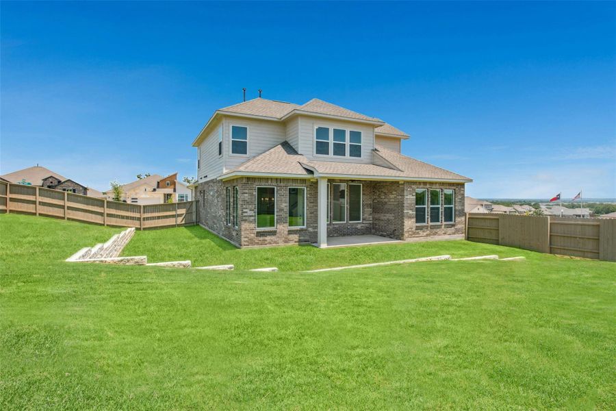 Front exterior of a new home in The Colony, Bastrop, TX, highlighting curb appeal (Image 15). Front exterior of a new home in The Colony, Bastrop, TX, highlighting curb appeal (Image 15).