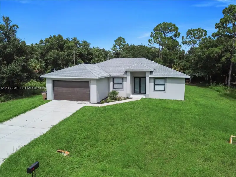 Front exterior of a new home in , Lehigh Acres, FL, highlighting curb appeal (Image 19).