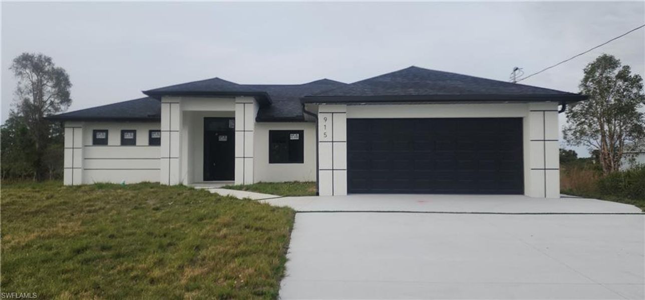 Front exterior of a new home in , Lehigh Acres, FL, highlighting curb appeal (Image 14).