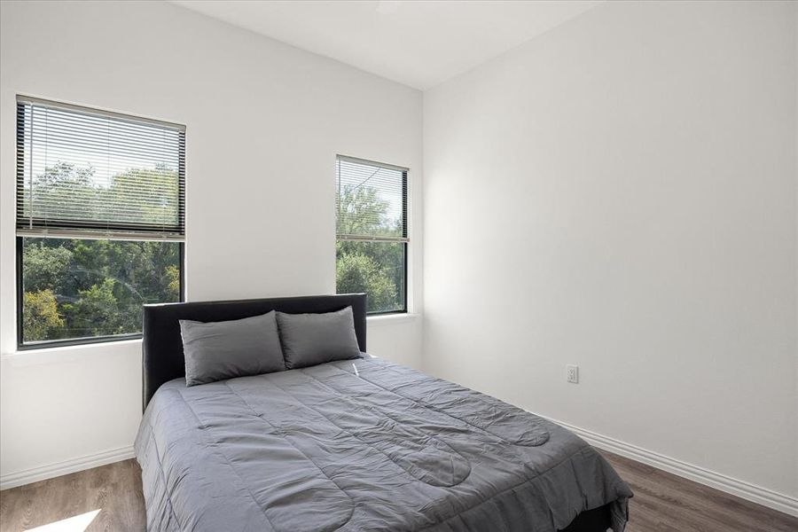 Bedroom with hardwood / wood-style floors