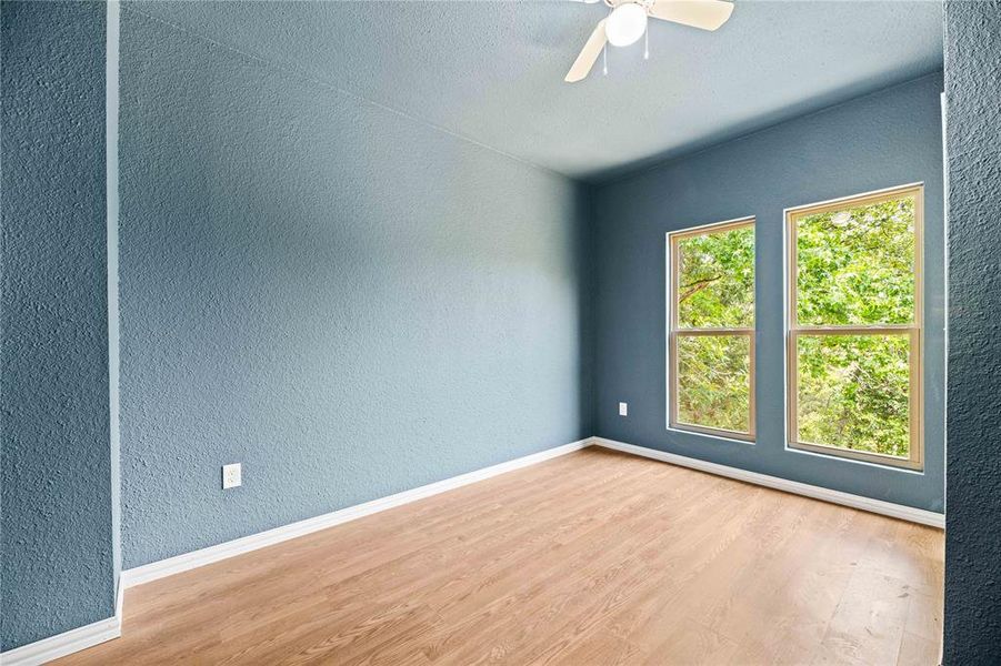 Unfurnished room featuring ceiling fan and light hardwood / wood-style flooring Unfurnished room featuring ceiling fan and light hardwood / wood-style flooring