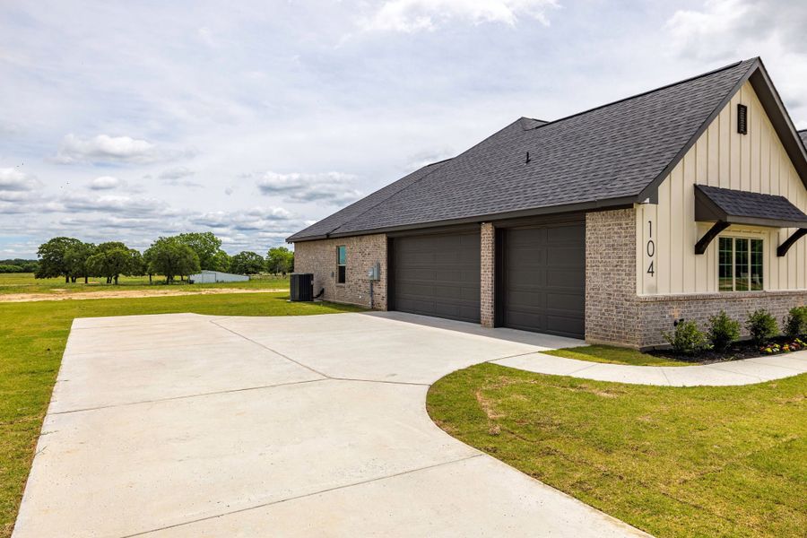 Front exterior of a new home in Prairie Winds Estates, Poolville, TX, highlighting curb appeal (Image 26). Front exterior of a new home in Prairie Winds Estates, Poolville, TX, highlighting curb appeal (Image 26).