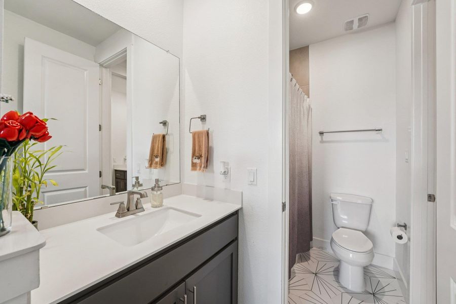 Thoughtfully placed lighting and mirrors enhance brightness and create a polished look.