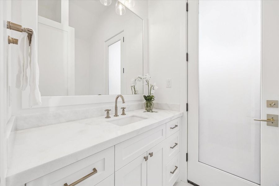 Thoughtfully designed powder bath features clean lines, stone countertops, and generous vanity storage. Positioned for guests, it offers a polished touch without interrupting the main living areas. **Previous build by Arch Angelo** Thoughtfully designed powder bath features clean lines, stone countertops, and generous vanity storage. Positioned for guests, it offers a polished touch without interrupting the main living areas. **Previous build by Arch Angelo**
