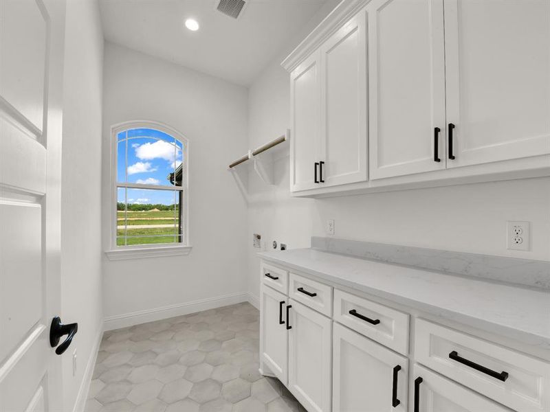 Washroom with cabinet space, washer hookup, recessed lighting, and baseboards Washroom with cabinet space, washer hookup, recessed lighting, and baseboards