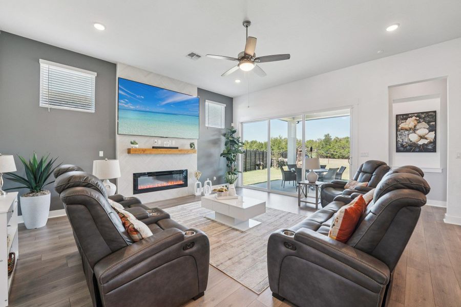 The spacious living room is the heart of the home, filled with natural light and a seamless connection to the outdoors.