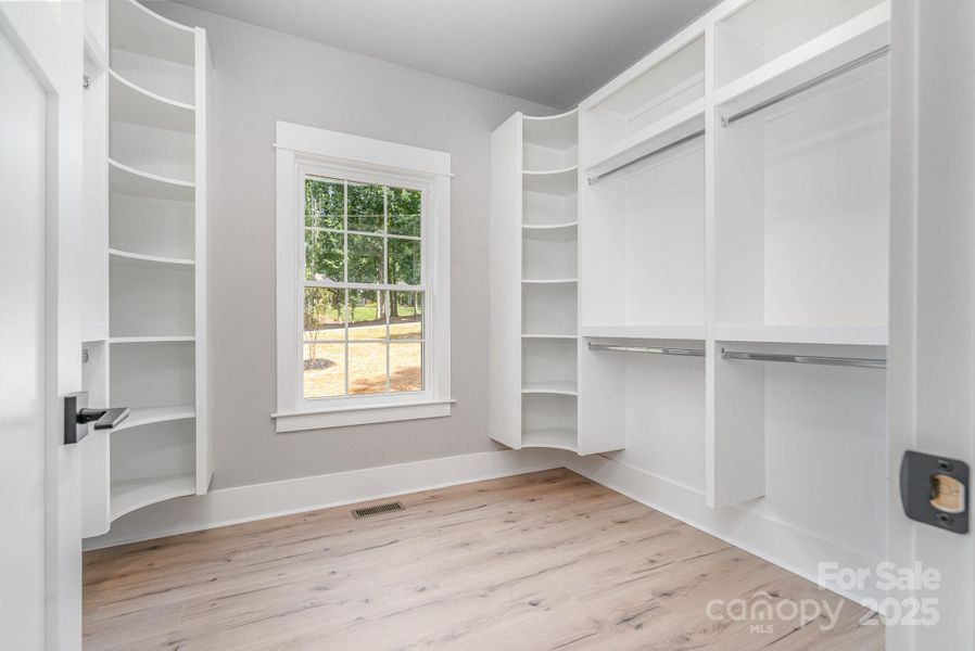 Walk in closet with wooden shelves