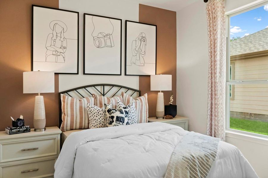 Secondary bedroom features plush carpet, neutral paint, lighting, large window, and an ample spaced closet.