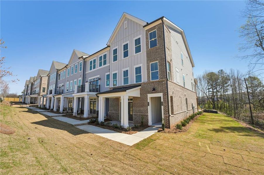 Front exterior of a new home in Market Square at Sawnee Village, Cumming, GA, highlighting curb appeal (Image 22).