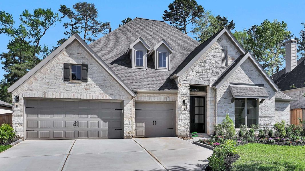 Front exterior of a new home in The Woodlands Hills 75', Willis, TX, highlighting curb appeal (Image 12).