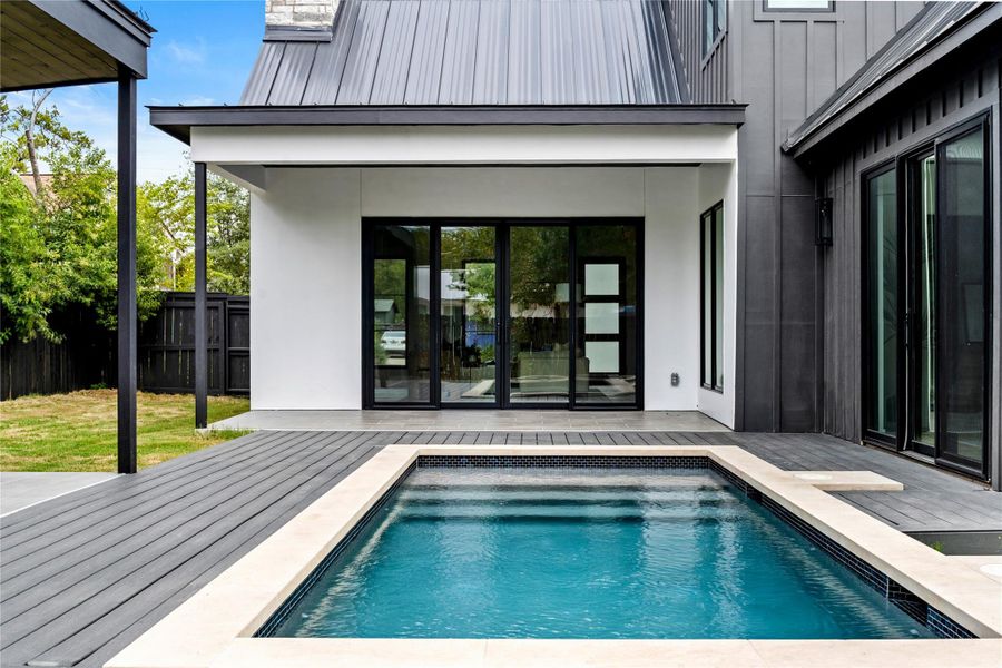 View of pool featuring a patio area and a wooden deck