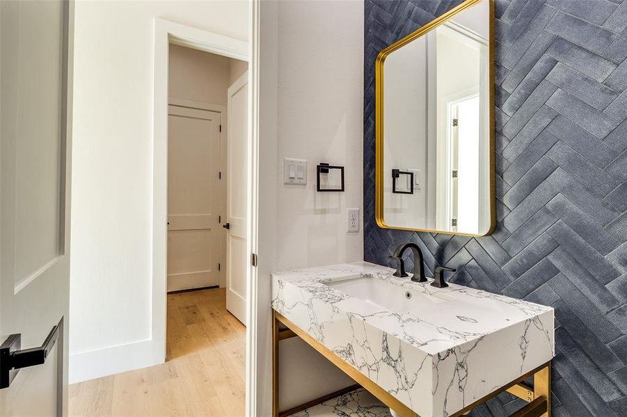 Bathroom with vanity, tasteful backsplash, and hardwood / wood-style flooring