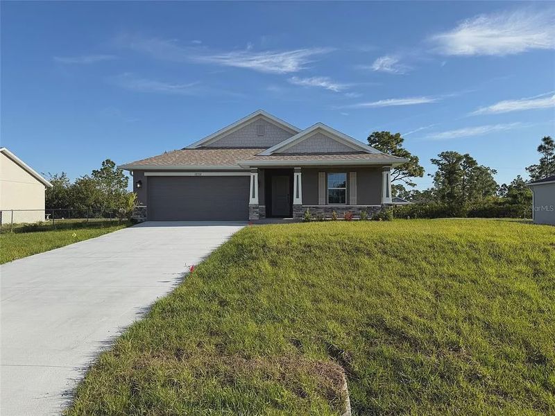 Front exterior of a new home in Gulf Cove, Port Charlotte, FL, highlighting curb appeal (Image 1). Front exterior of a new home in Gulf Cove, Port Charlotte, FL, highlighting curb appeal (Image 1).