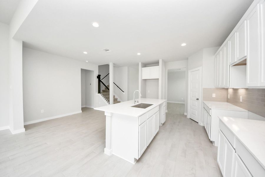 The open concept effortlessly connects the kitchen to the expansive family room, forming a perfect hub for gatherings. This seamless flow creates an inviting space where cooking and socializing come together harmoniously. The open concept effortlessly connects the kitchen to the expansive family room, forming a perfect hub for gatherings. This seamless flow creates an inviting space where cooking and socializing come together harmoniously.