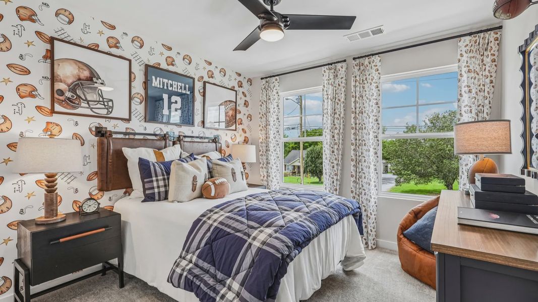 Secondary bedroom with carpet and windows