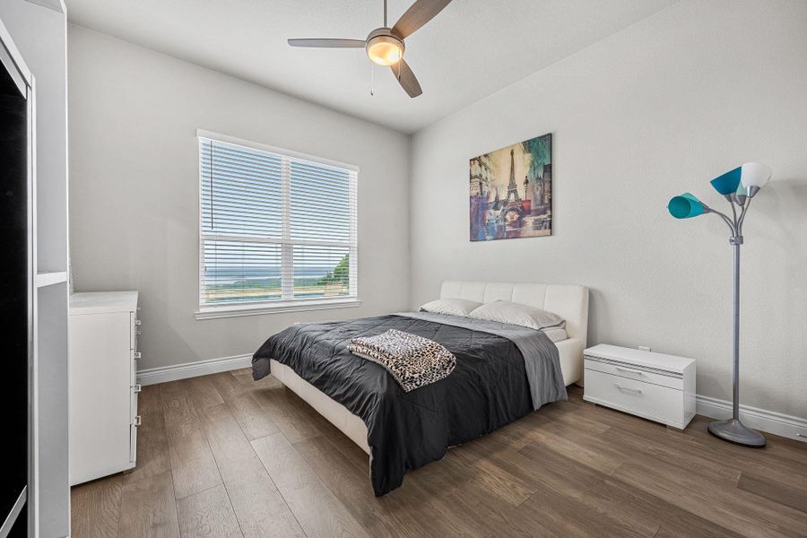 Well-lit sleeping quarters with a broad window capturing the outdoor panorama. Well-lit sleeping quarters with a broad window capturing the outdoor panorama.