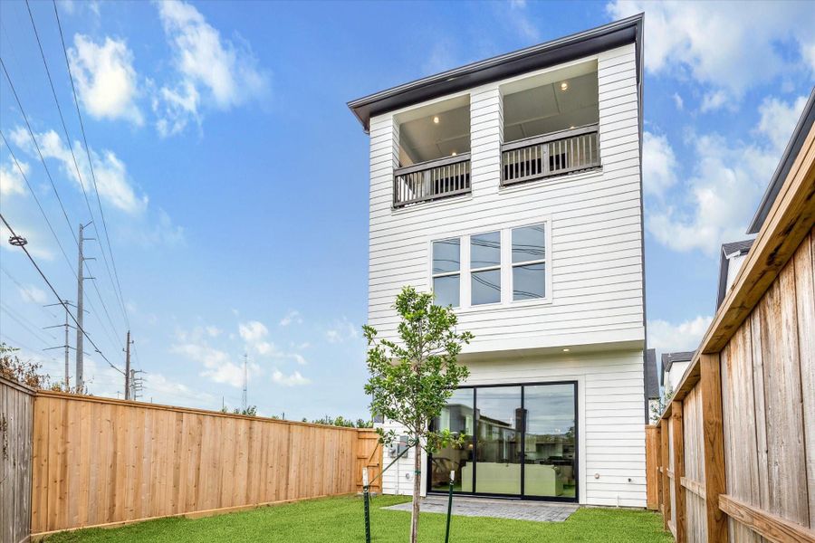 10ft glass sliding doors lead from living room into backyard