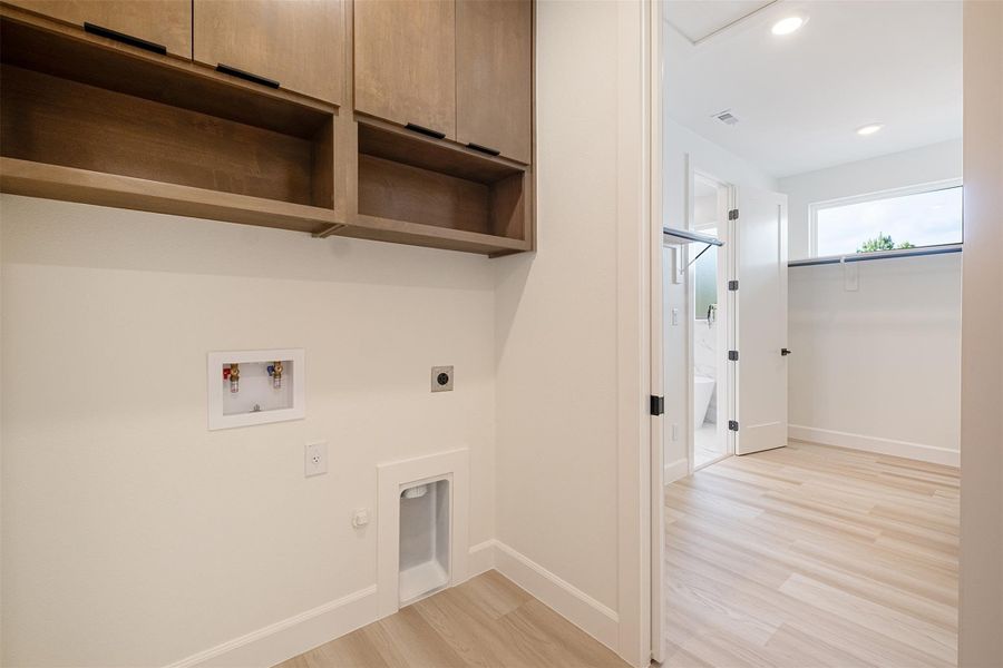Laundry room with light wood-type flooring, gas dryer hookup, hookup for a washing machine, recessed lighting, and electric dryer hookup