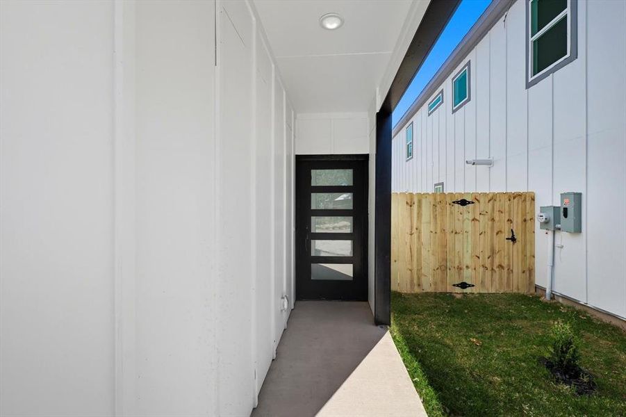 Modern entry door with horizontal frosted glass inserts and black hardware Modern entry door with horizontal frosted glass inserts and black hardware