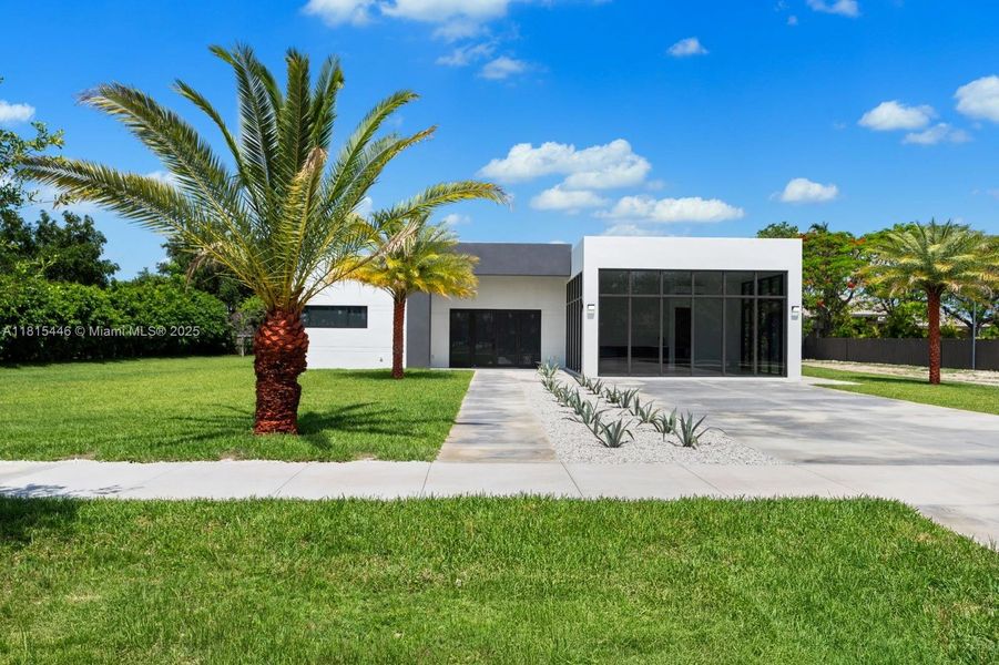 Front exterior of a new home in , Homestead, FL, highlighting curb appeal (Image 24).