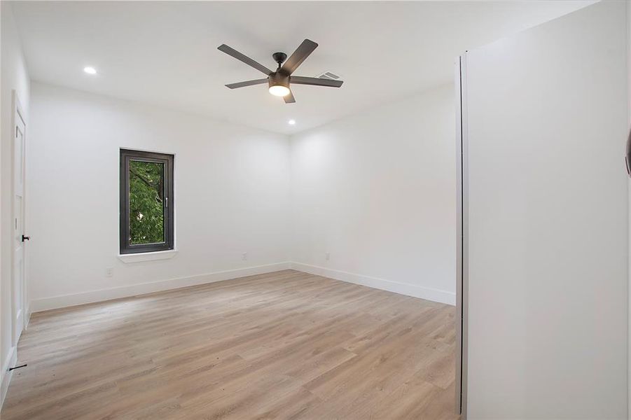 Spare room featuring ceiling fan and light hardwood / wood-style floors