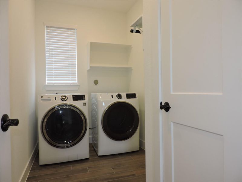 Spacious laundry with built-in clothes hanging bar and storage shelf's, Brand New Washer and Dryer included! Additional storage closet inside the room.
