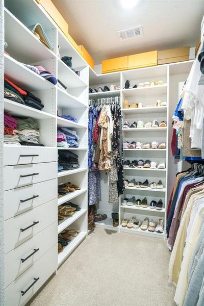 Boutique-Style Closet - Custom built-ins and full-height shelving provide abundant storage in this walk-in closet—perfectly tailored for organized living. Boutique-Style Closet - Custom built-ins and full-height shelving provide abundant storage in this walk-in closet—perfectly tailored for organized living.