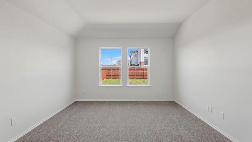 Interior room featuring a tray ceiling, two windows, wall-to-wall carpeting, and white baseboards