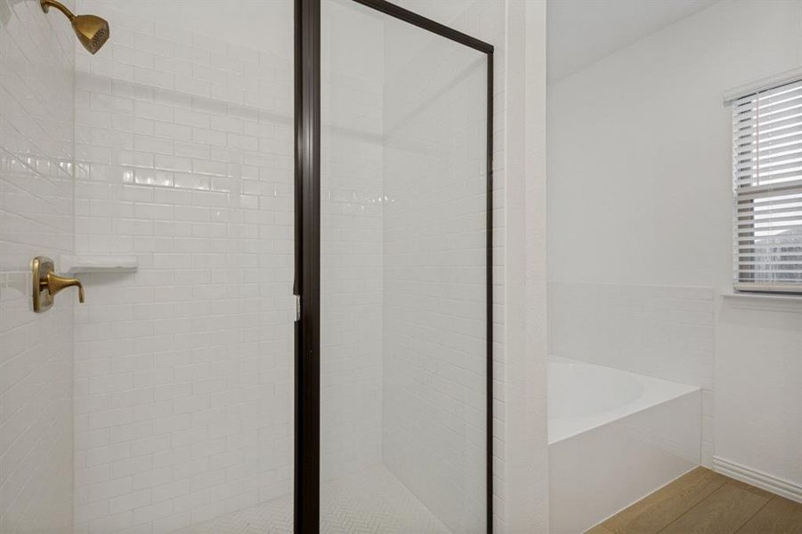 Shower with white subway tile surround, bronze fixtures, and a glass enclosure