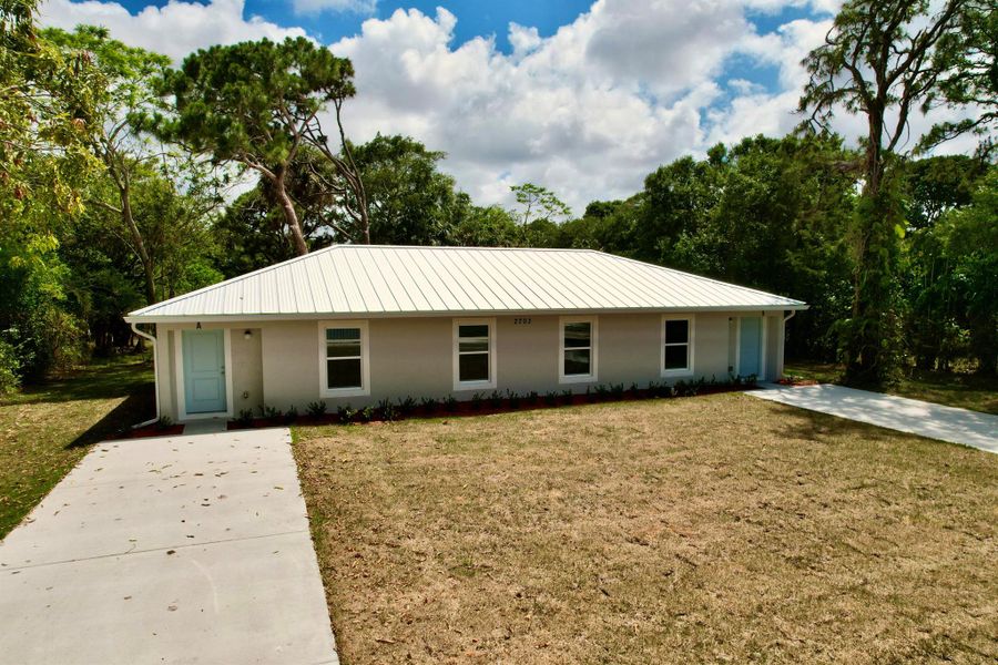 Front exterior of a new home in , Fort Pierce, FL, highlighting curb appeal (Image 1). Front exterior of a new home in , Fort Pierce, FL, highlighting curb appeal (Image 1).
