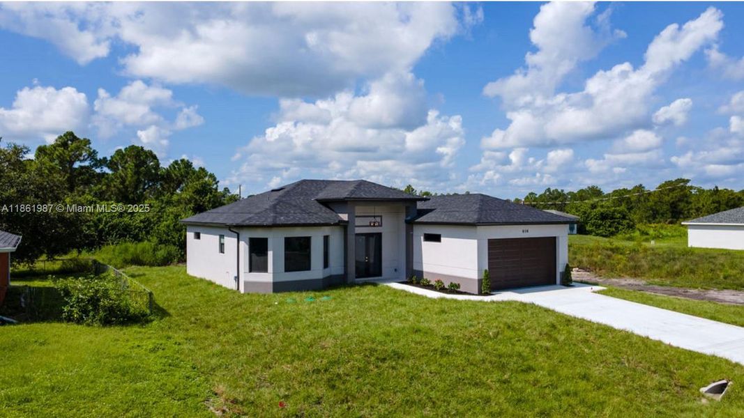 Front exterior of a new home in , Lehigh Acres, FL, highlighting curb appeal (Image 21). Front exterior of a new home in , Lehigh Acres, FL, highlighting curb appeal (Image 21).