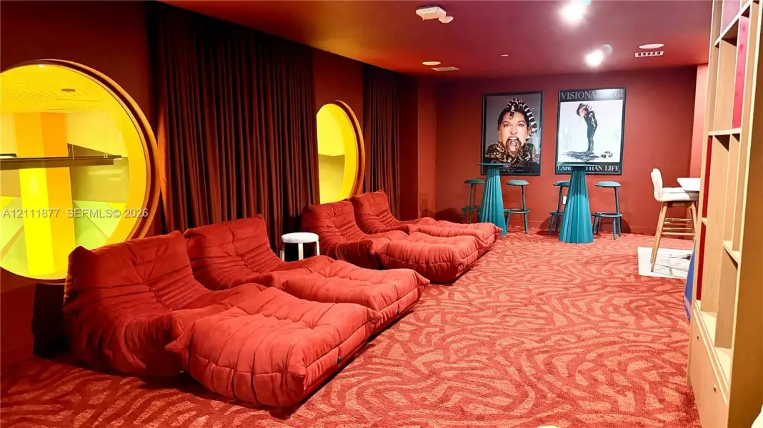 Custom circular windows with integrated lighting, wall-to-wall patterned carpet, and built-in floor-to-ceiling shelving