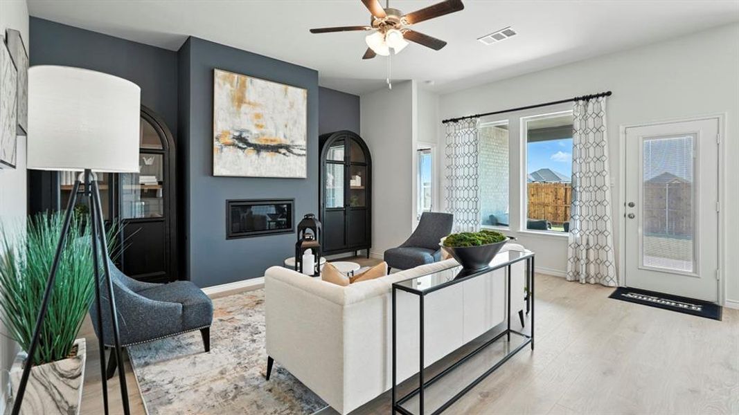 Living area featuring wood-finish flooring, recessed lighting, and a ceiling fan