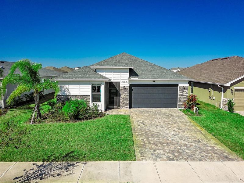 Front exterior of a new home in , Palm Bay, FL, highlighting curb appeal (Image 2).