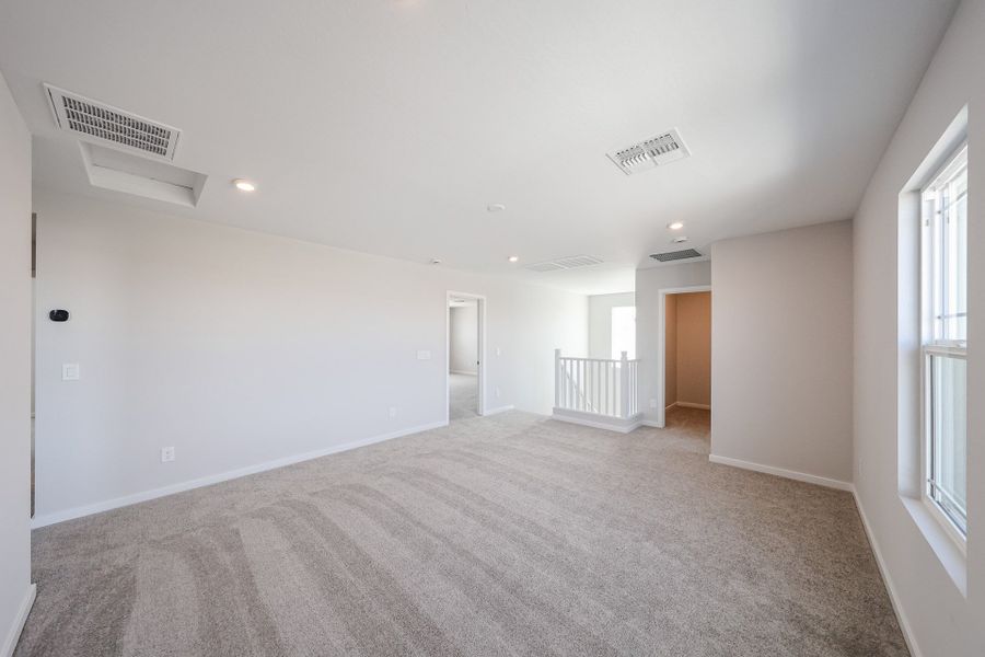 A long hallway with a carpet.