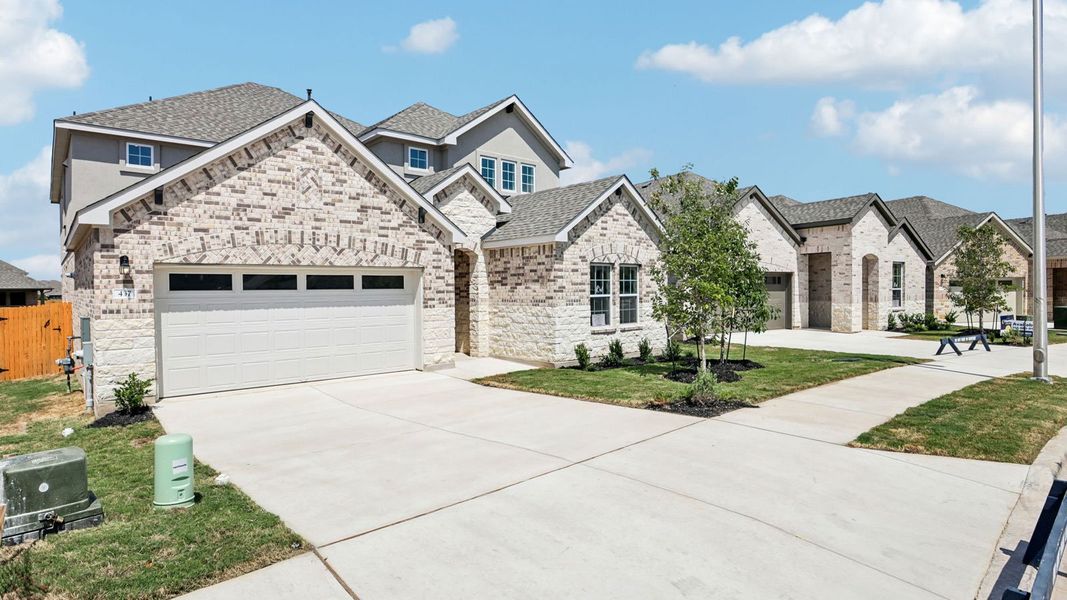 Front exterior of a new home in Rosenbusch Ranch, Leander, TX, highlighting curb appeal (Image 23).