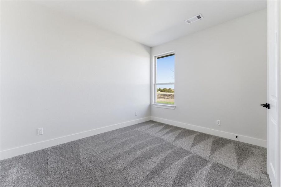 Unfurnished room with carpet and baseboards