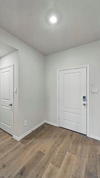 Spare room with wood finished floors and baseboards