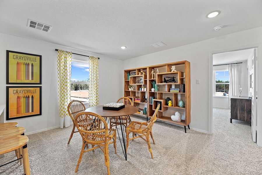 A room with a table and chairs.