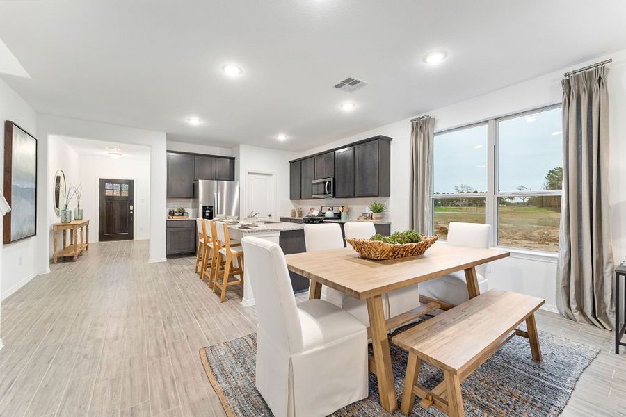 A large kitchen with a dining table. A large kitchen with a dining table.