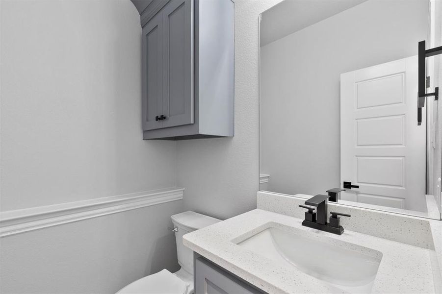 Bathroom featuring vanity and toilet