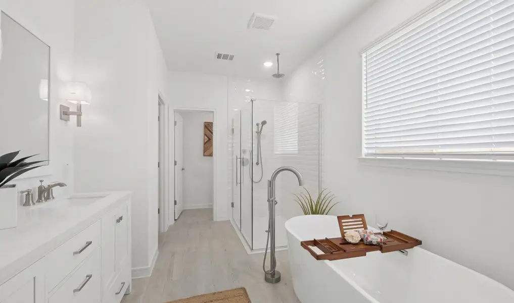 Primary bath features freestanding soaking tub