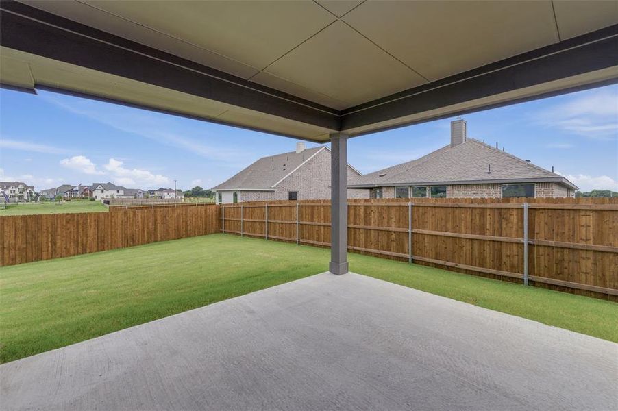 Covered patio featuring a concrete slab and a single support pillar Covered patio featuring a concrete slab and a single support pillar