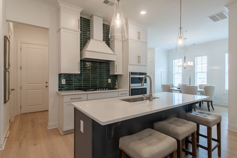 Stylish kitchen with a center island that includes a low bar top