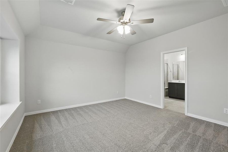 Empty room with light carpet, lofted ceiling, and ceiling fan