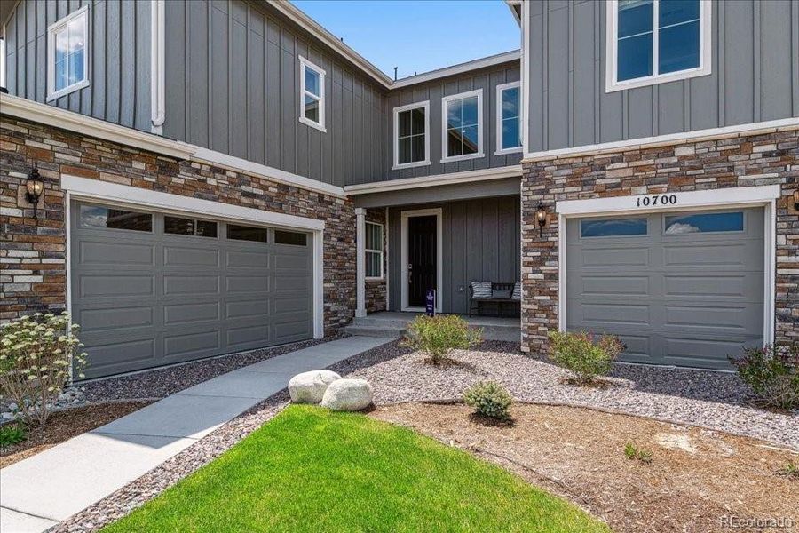 Front exterior of a new home in Trails at Smoky Hill, Parker, CO, highlighting curb appeal (Image 18).