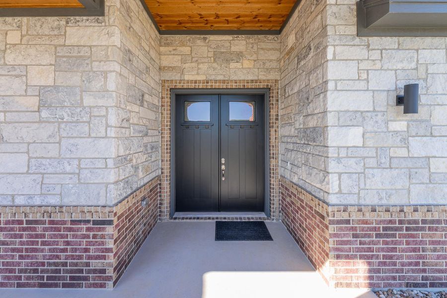 Property entrance with stone siding Property entrance with stone siding