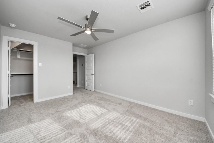 Generously sized secondary bedrooms featuring spacious closets, soft and inviting carpeting underfoot, large windows allowing plenty of natural light, and the added touch of privacy blinds for your personal retreat.