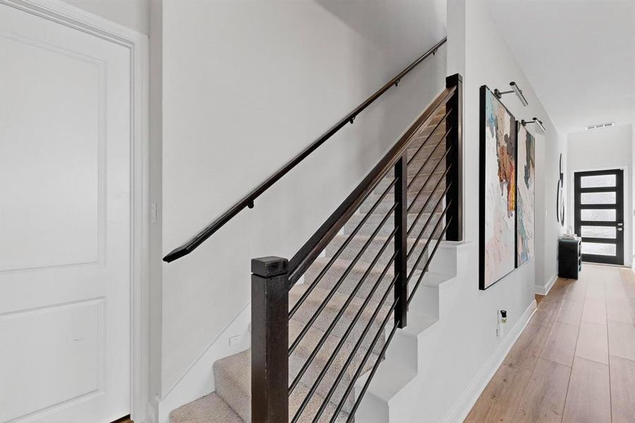 Stairway with wood finished floors and baseboards Stairway with wood finished floors and baseboards